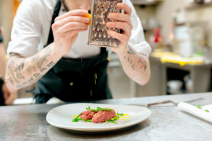 Chef preparing raw meat dish in kitchen Chef preparing raw meat dish in kitchen